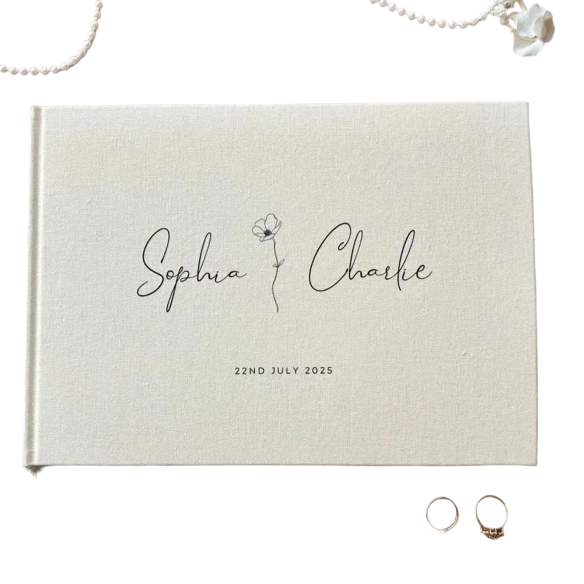 Personalized beige linen wedding guest book with black cursive script and flower illustration dated July 22nd 2025