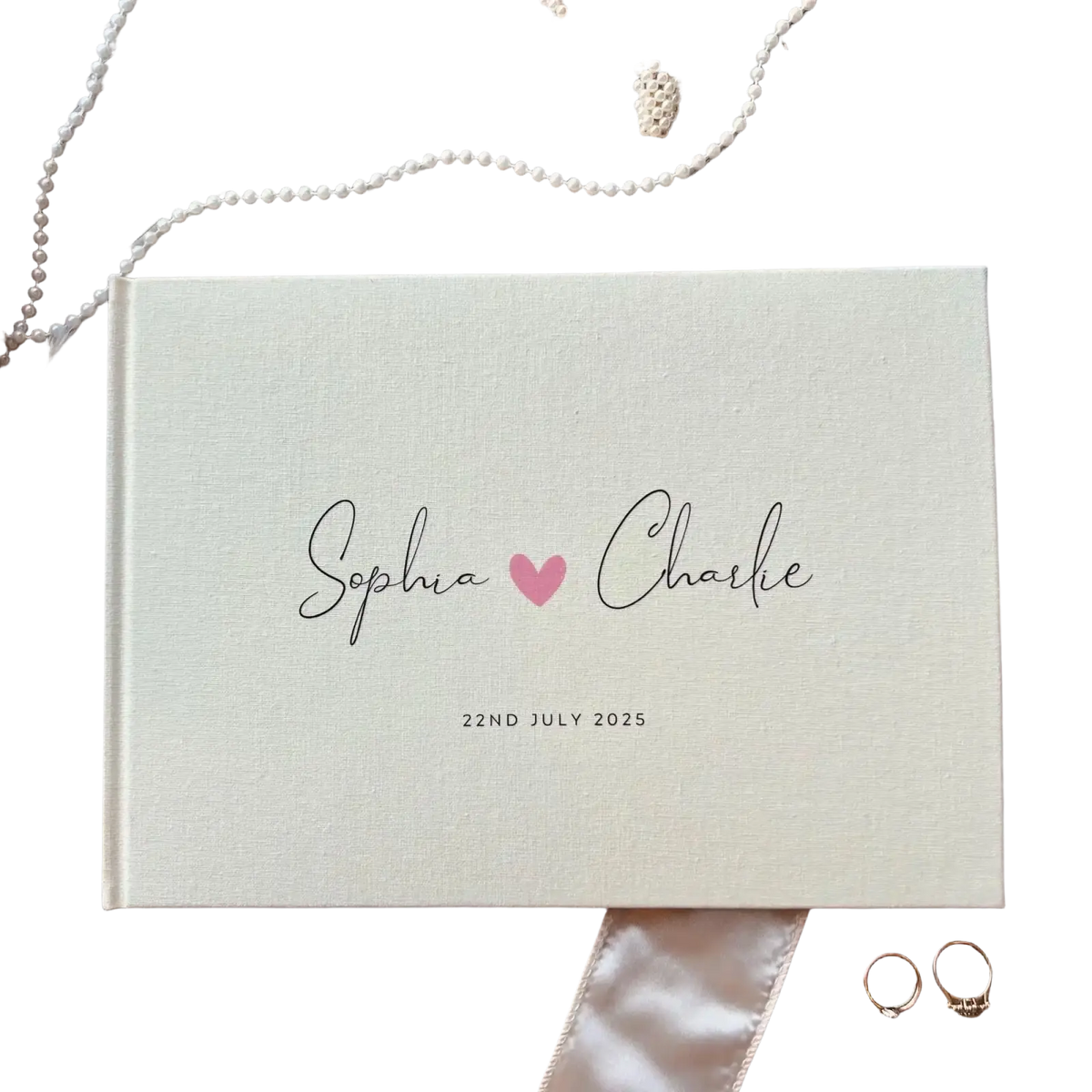 Personalized cream linen wedding guest book polaroid album with black cursive script and pink heart detail dated july 22 2025
