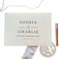 Personalized cream-colored linen wedding guest book polaroid album with black engraved text for sophia and charlie 2025