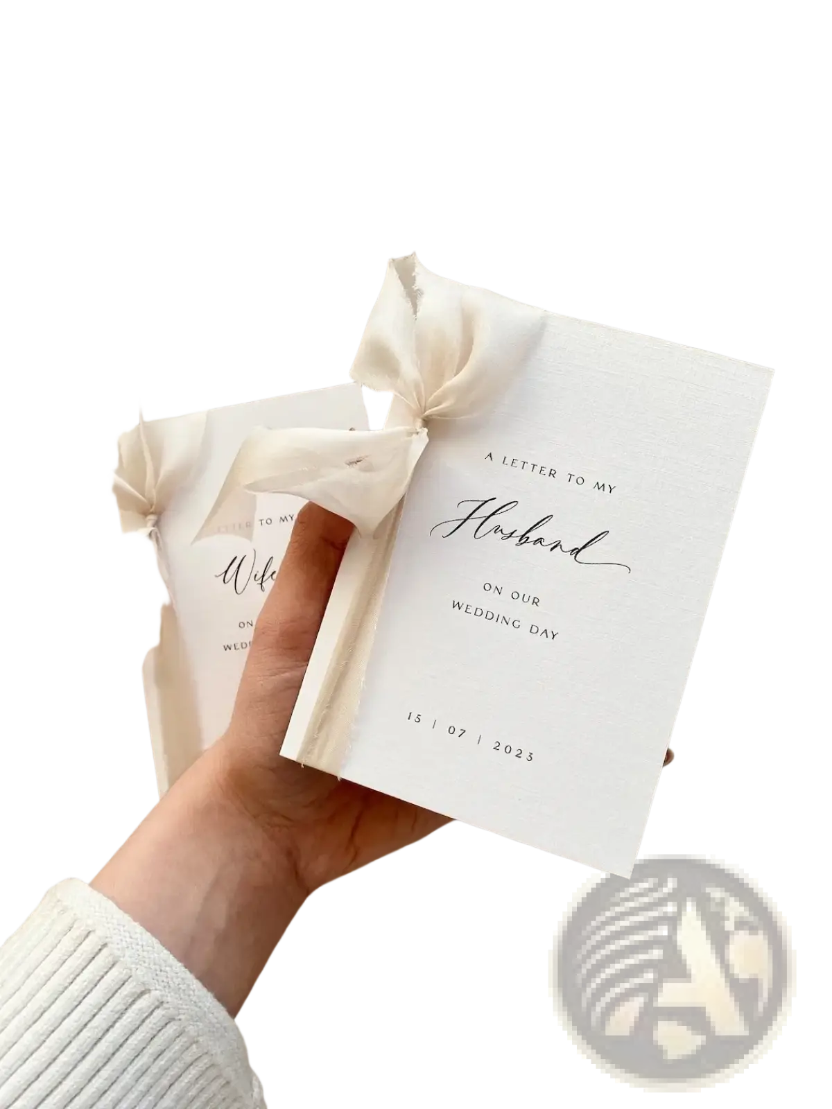 A minimalist white wedding letterbook adorned with a delicate ivory satin ribbon bow personalized for weddings