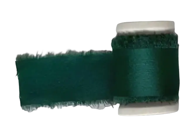 Emerald green frayed-edge ribbon on a spool for personalized minimalist wedding letter books set decoration