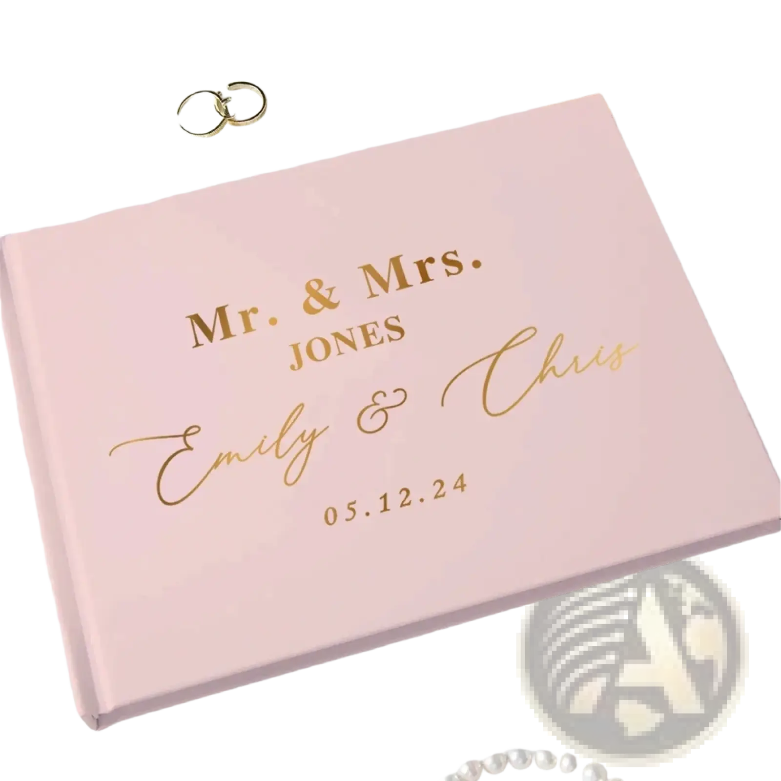Personalized pink wedding guest book with gold foil lettering and elegant script design including a pen