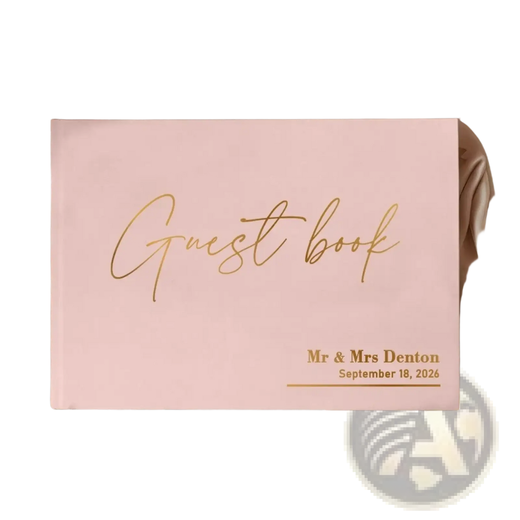 Personalized pink wedding guest book with pen featuring soft hardcover finish and elegant gold cursive lettering with date