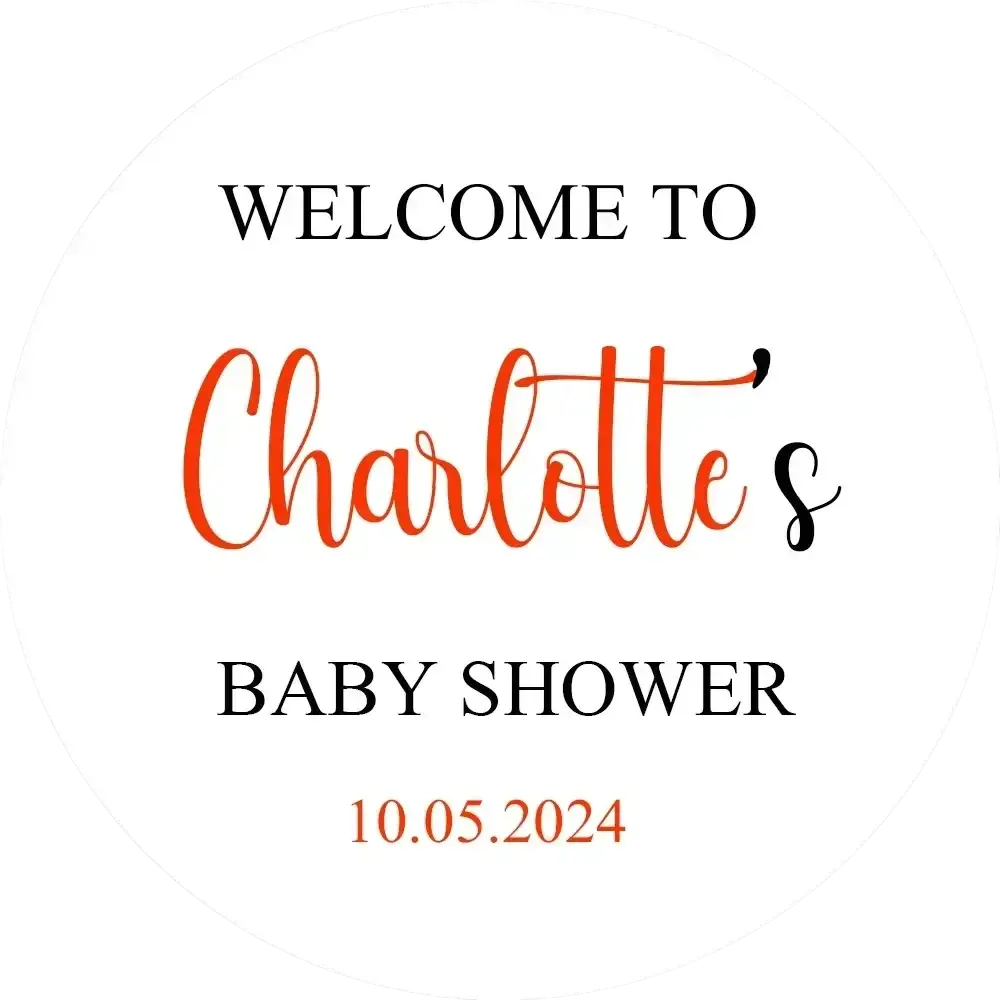Personalized white round baby shower sign kt board with welcome to charlotte’s baby shower in black and orange script dated 10.05.2024