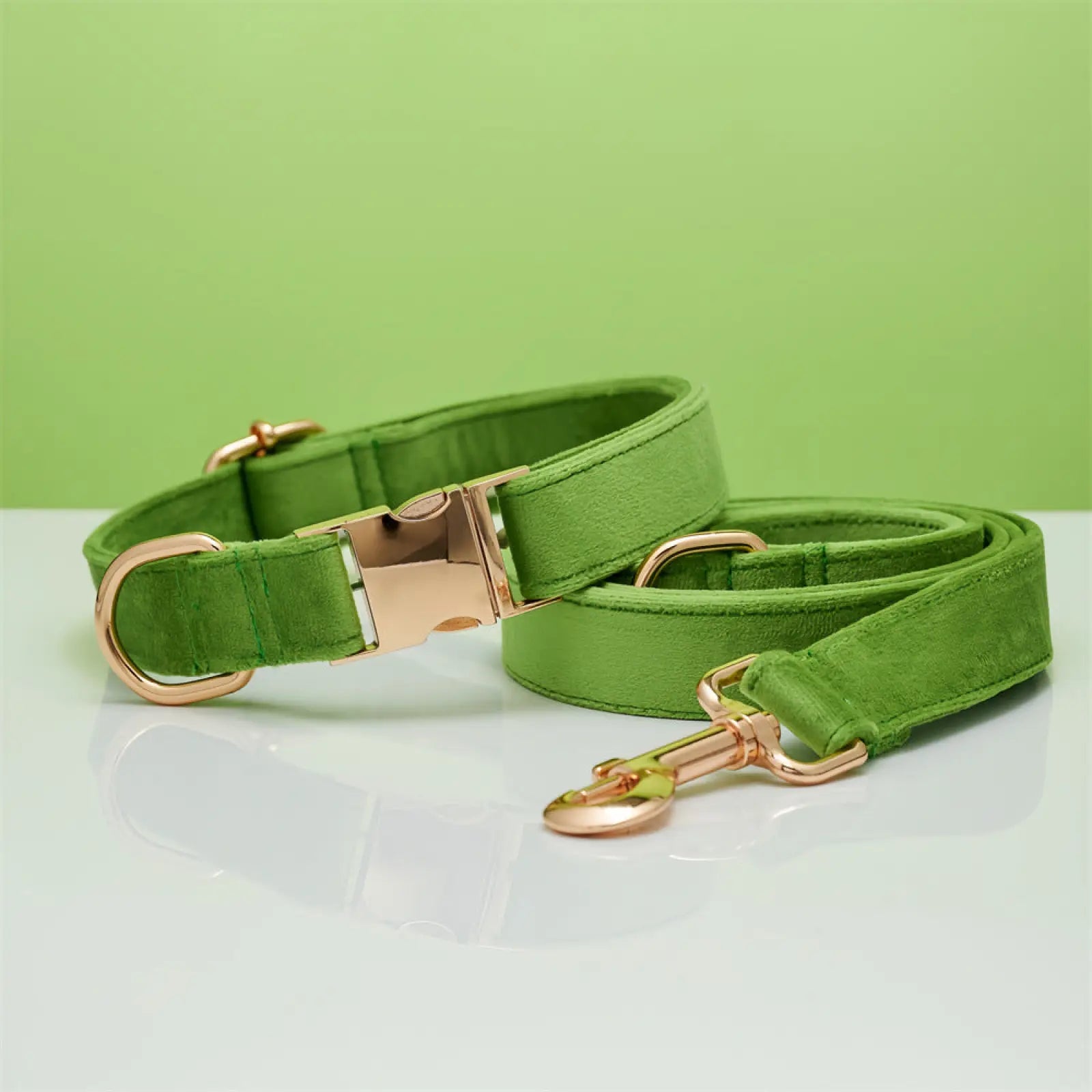 Personalized green suede dog collar and leash set with rose gold hardware and velvet bow detailing
