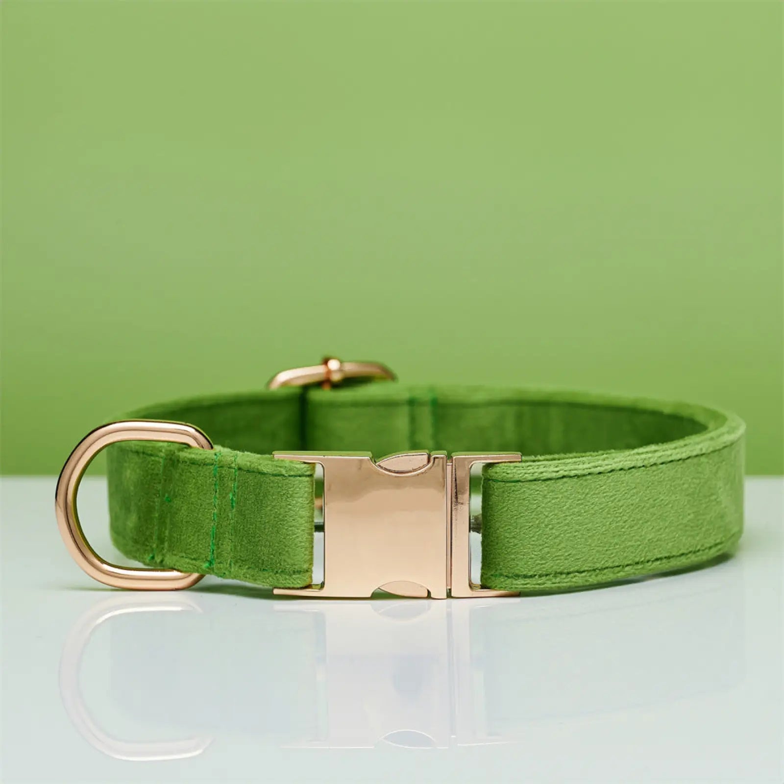 A sleek green suede personalized velvet dog collar with rose gold-toned metal buckle and d-ring