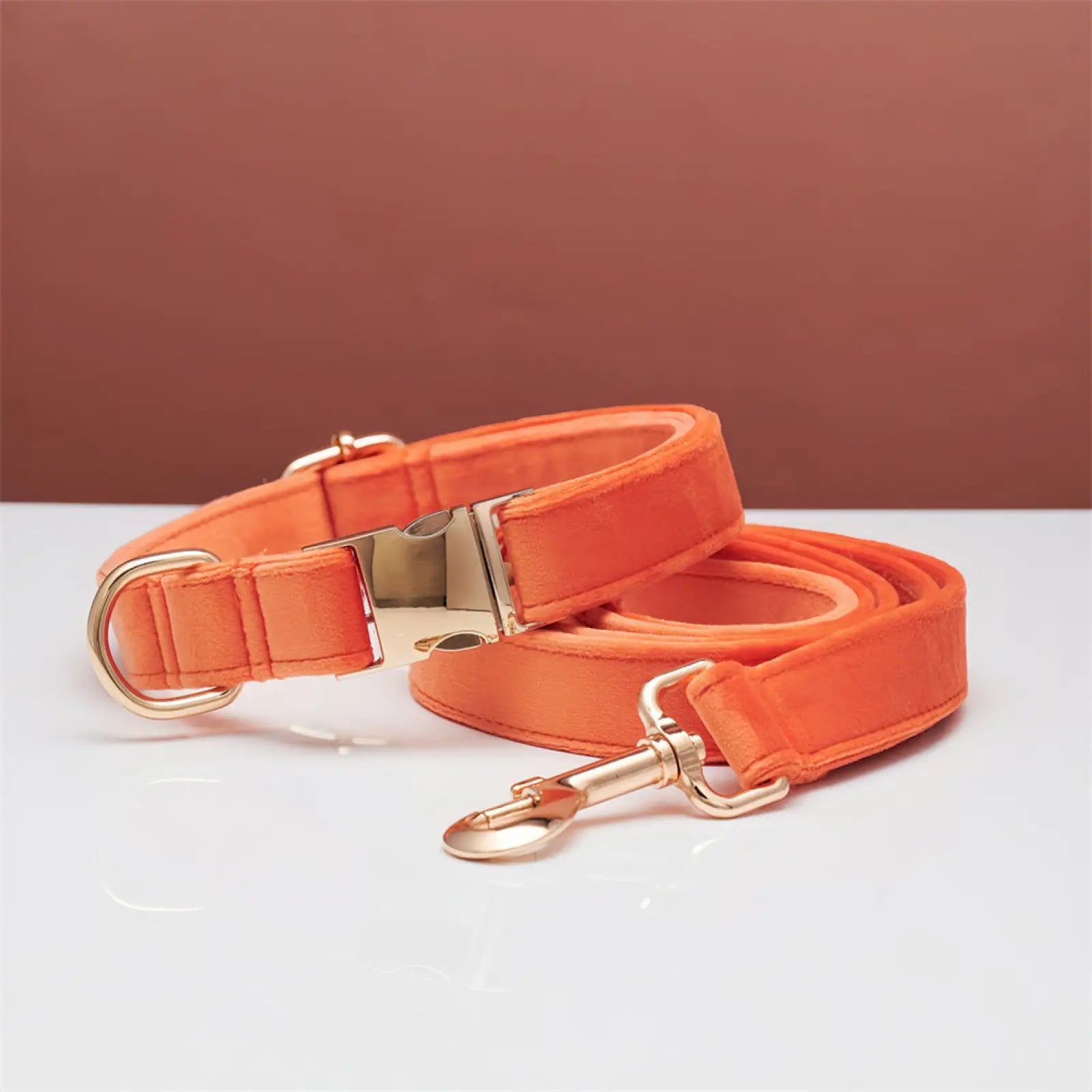 Personalized velvet dog collar and leash set in orangish orange satin with rose gold metal hardware and bow detail
