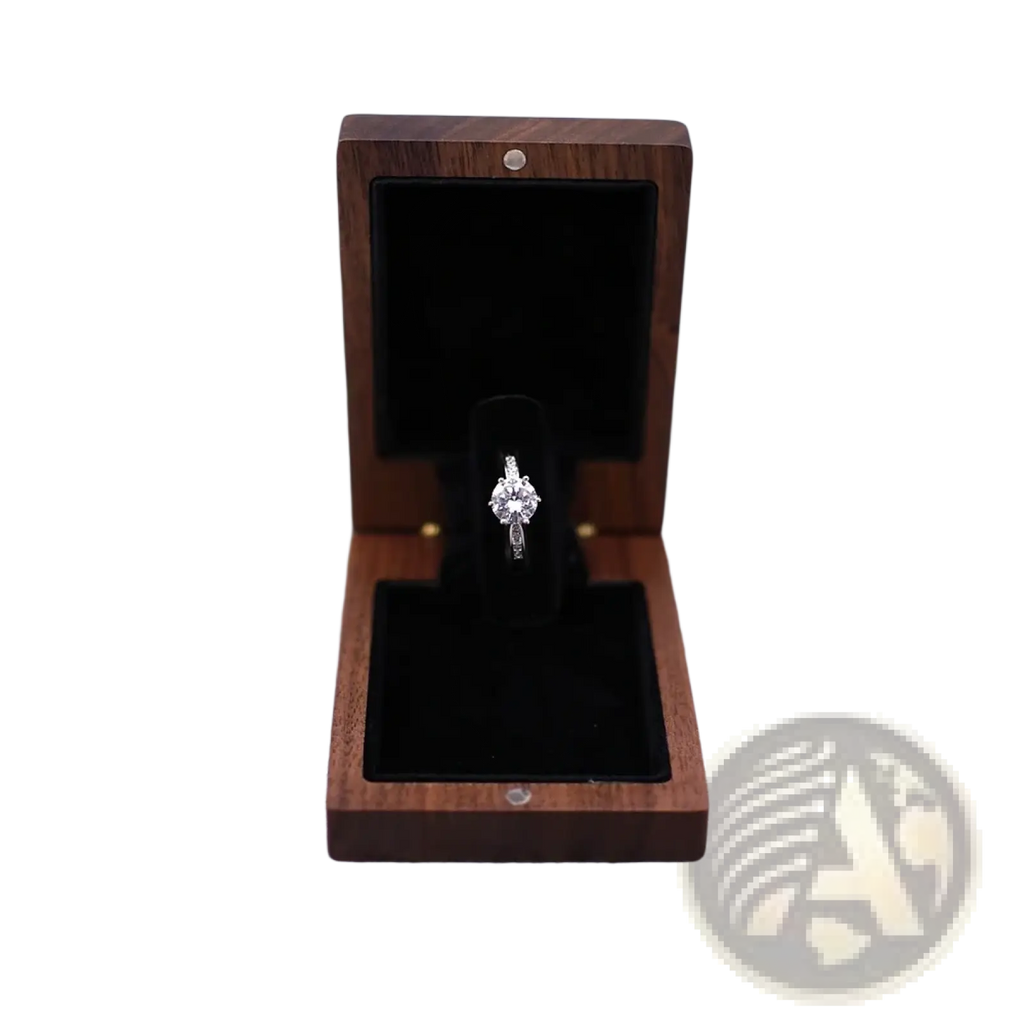 A personalized walnut wood wedding ring box displaying a sparkling diamond engagement ring with a silver band