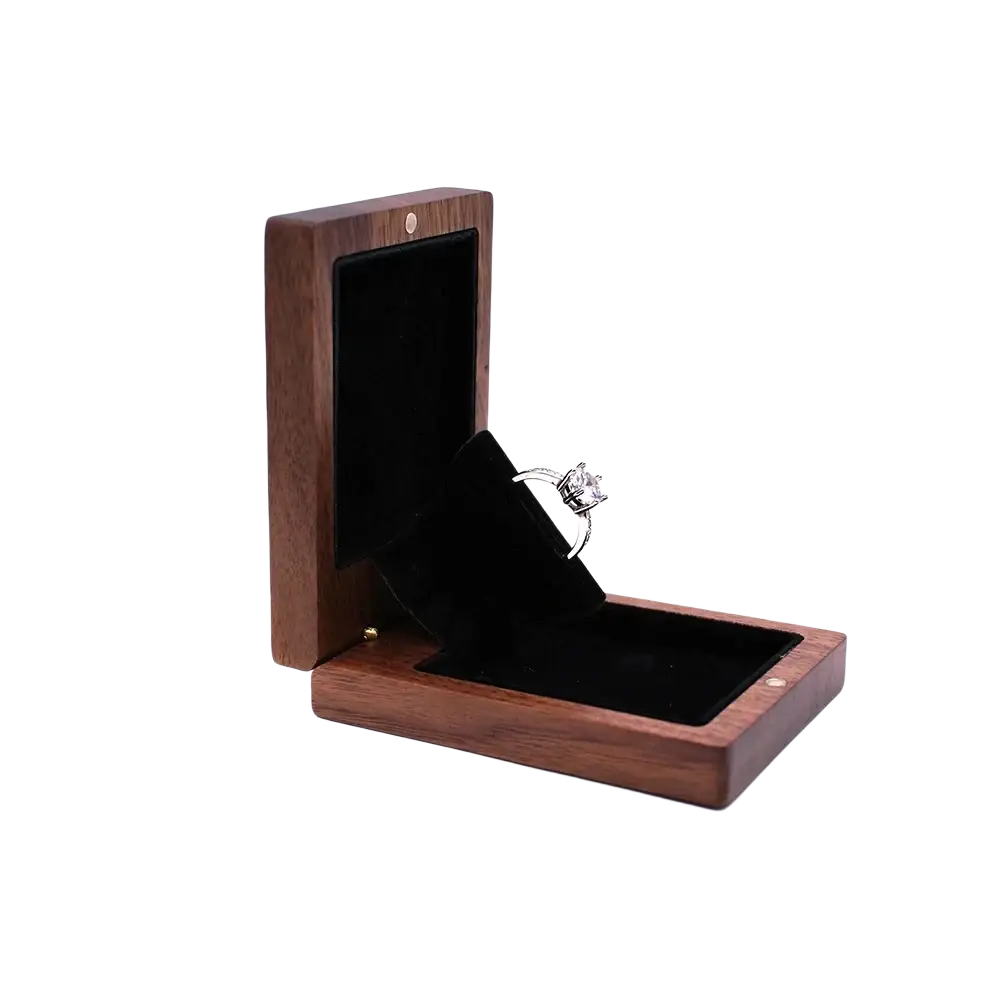 Personalized walnut wood wedding ring box displaying a silver engagement ring with central and smaller diamonds
