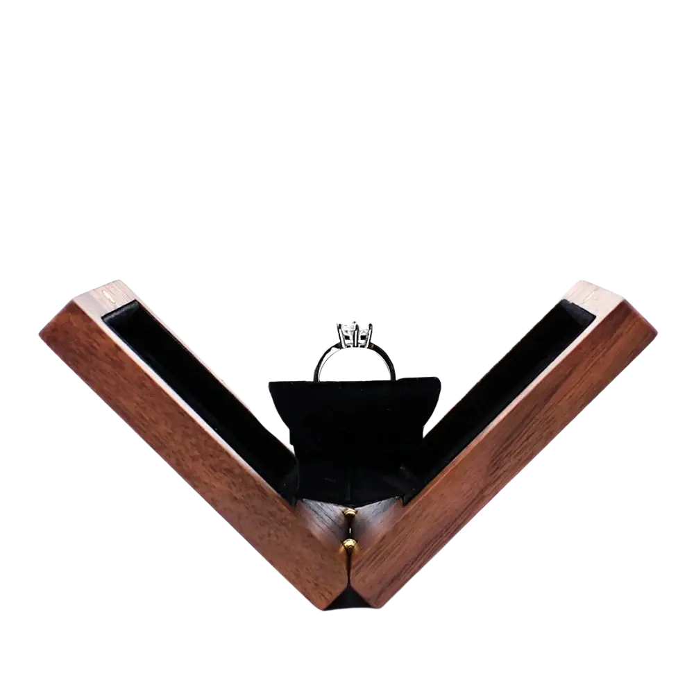 A sleek dark brown personalized walnut wood wedding ring box with black velvet interior holding a silver engagement ring
