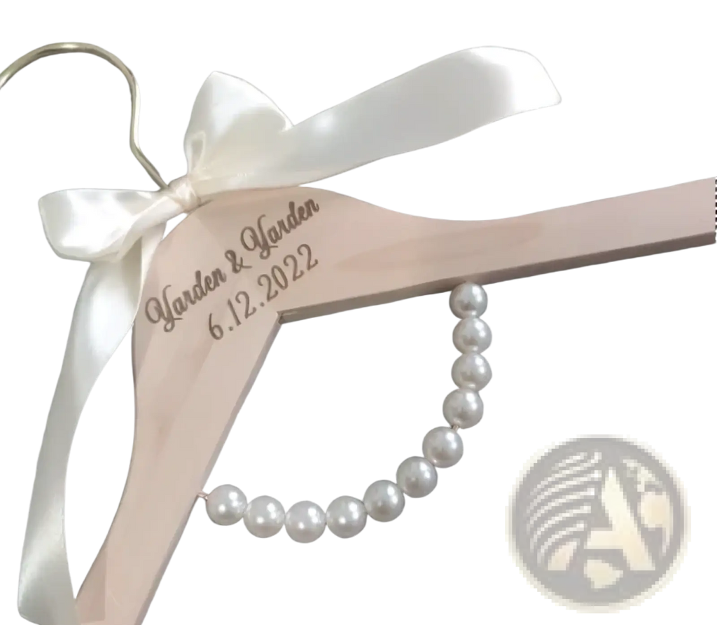 Personalized light pink wooden wedding dress hanger with white satin bow, engraved garden garden 6.12.2022, and pearl beads