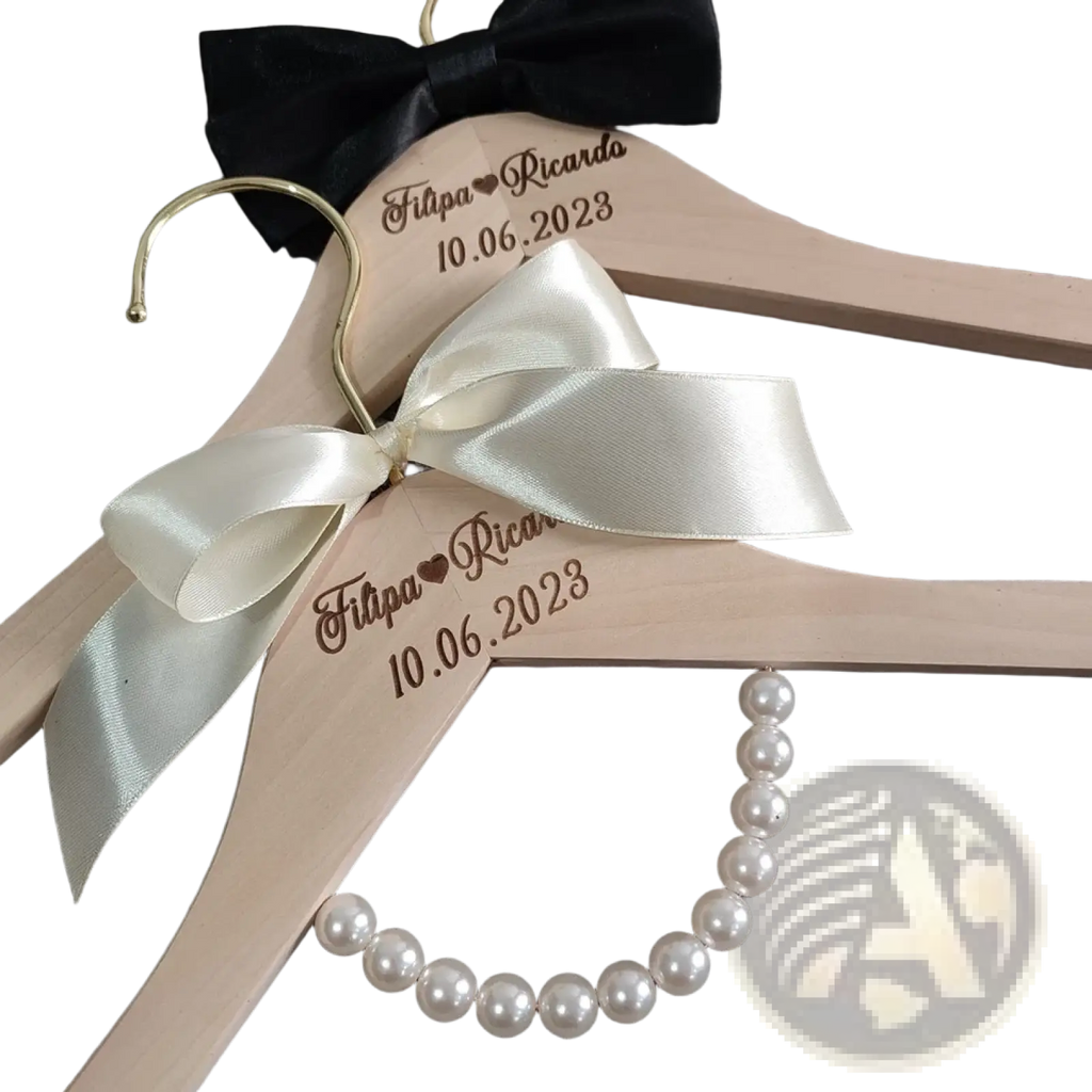 Personalized wedding dress hanger in light wood with cream satin bow black ribbon and custom engraved names and date