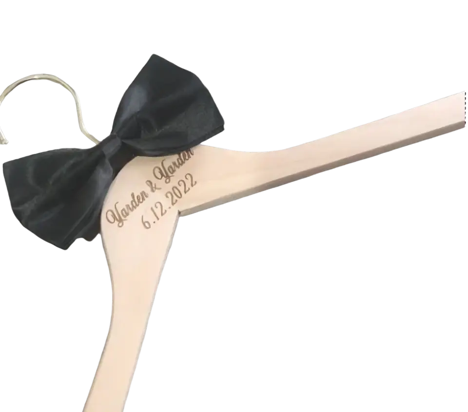 Light-colored wooden personalized wedding dress hanger with black satin bow and custom engraving garden & garden 6.12.2022