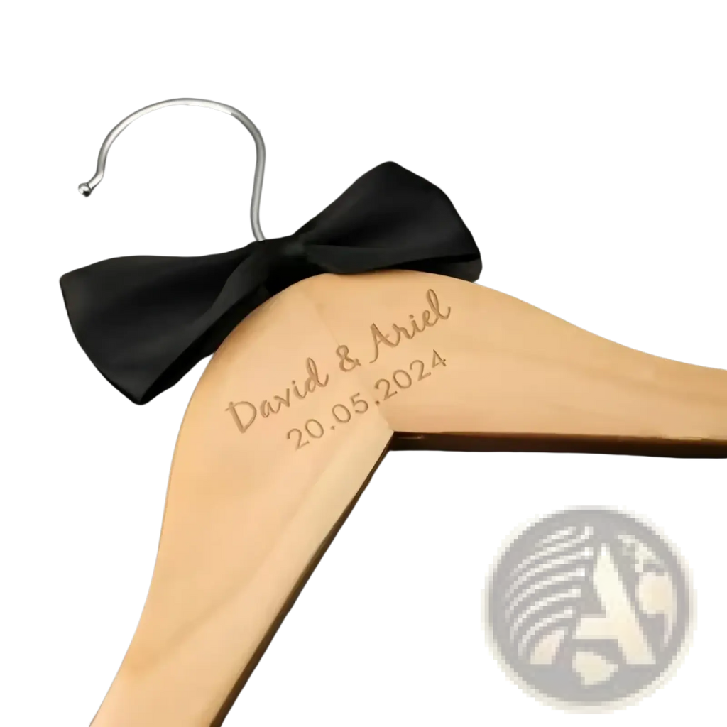 Personalized light-colored wooden wedding dress hanger with silver hook engraved david and ariel 20.05.2024 and black bow