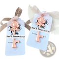 Personalized wedding key bottle opener favor with a rose-shaped key charm in rose gold finish on a light blue card