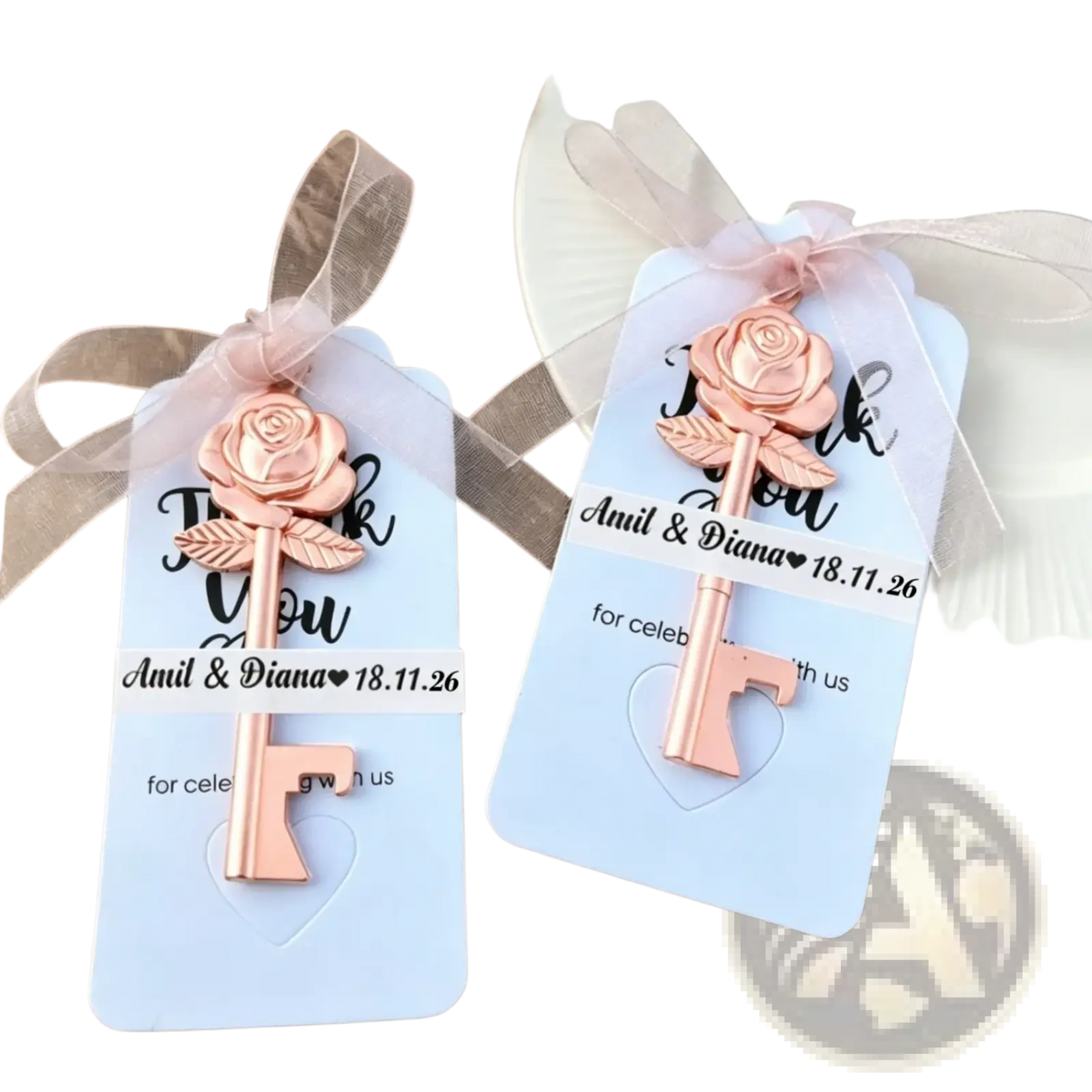 Personalized wedding key bottle opener favor with a rose-shaped key charm in rose gold finish on a light blue card
