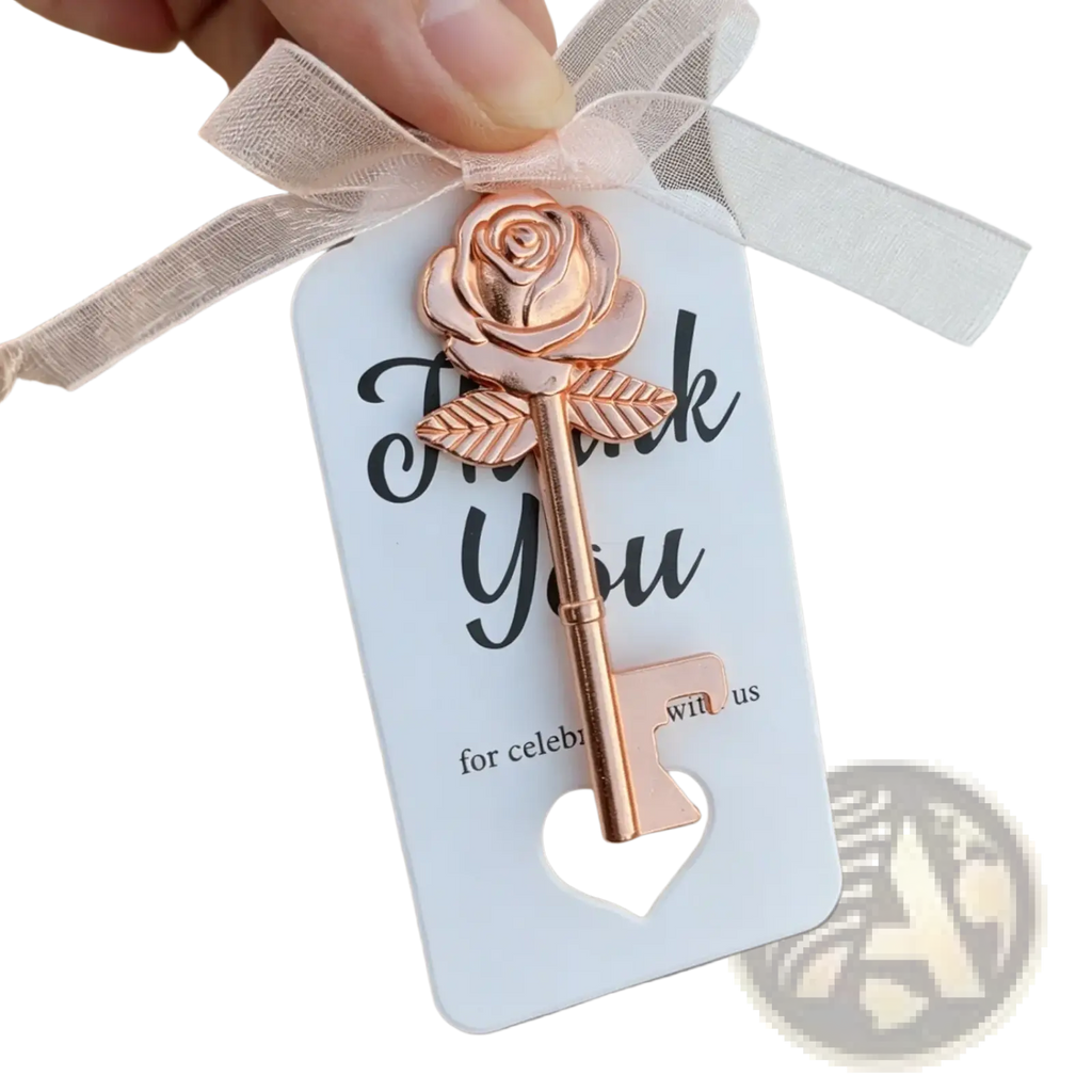 Personalized wedding key bottle opener favor in metallic rose gold shaped like a rose attached to a thank you card