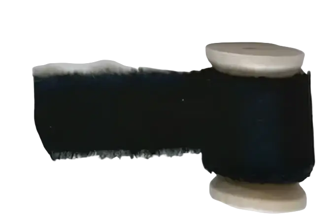 Black thread spool with a frayed edge and cream-colored wooden core for personalized wedding vow books set his and her