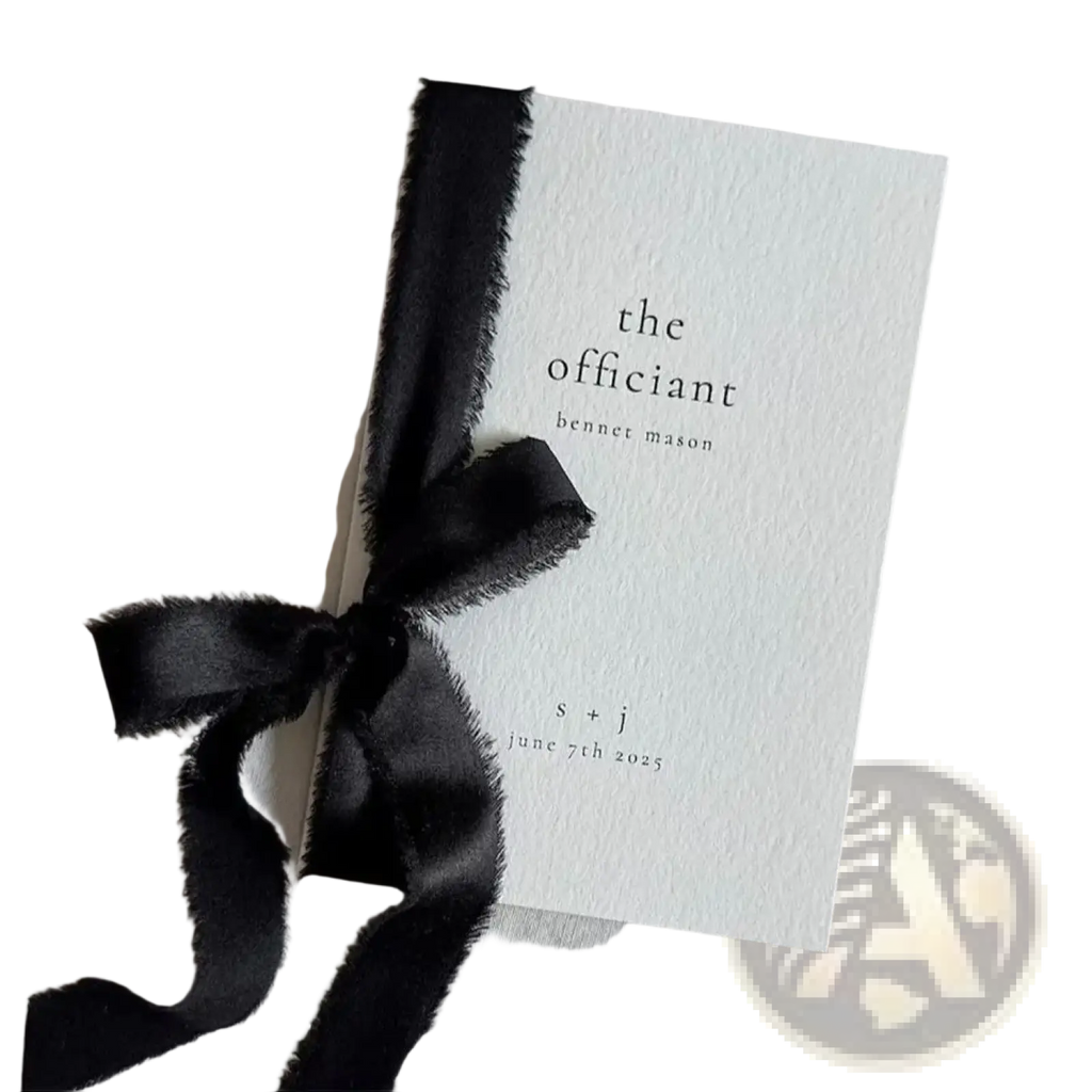 Minimalist white personalized wedding vow book with black text and frayed-edge black satin ribbon bow for his and her set