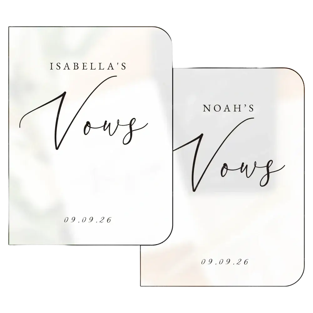 Two elegant white personalized wedding vow books set with black cursive script displaying names and date