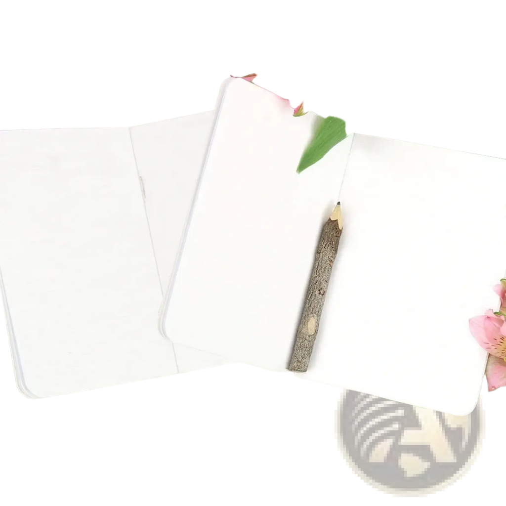 White personalized wedding vow books set with a rustic wooden pencil resting on open pages of the notebook