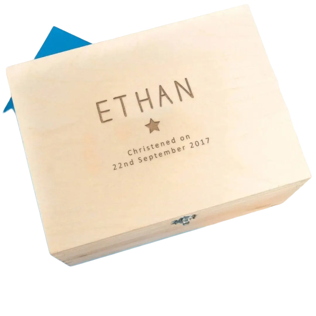 Light-colored wooden baptism keepsake box engraved with name Ethan date of christening and small star beneath name