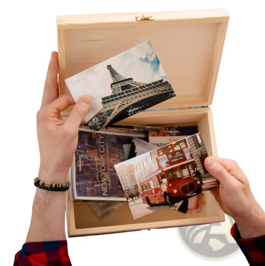 Light-colored wooden personalized baptism keepsake box with gold-toned latch holding travel postcards