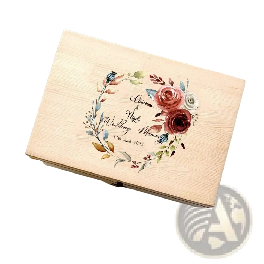 A light wood personalized wooden floral wedding memory box with watercolor floral wreath and engraved names and date