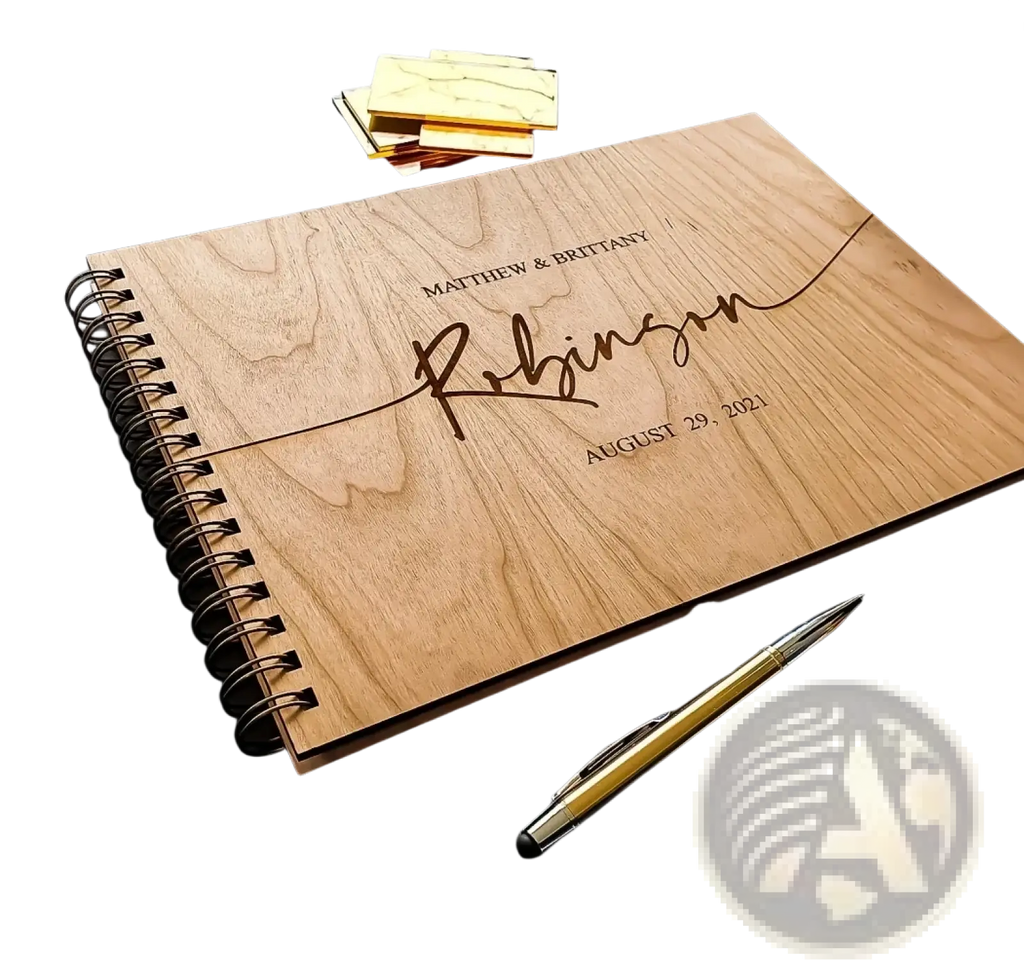 A light brown wooden wedding guest book album with laser-engraved personalized name and date on the cover