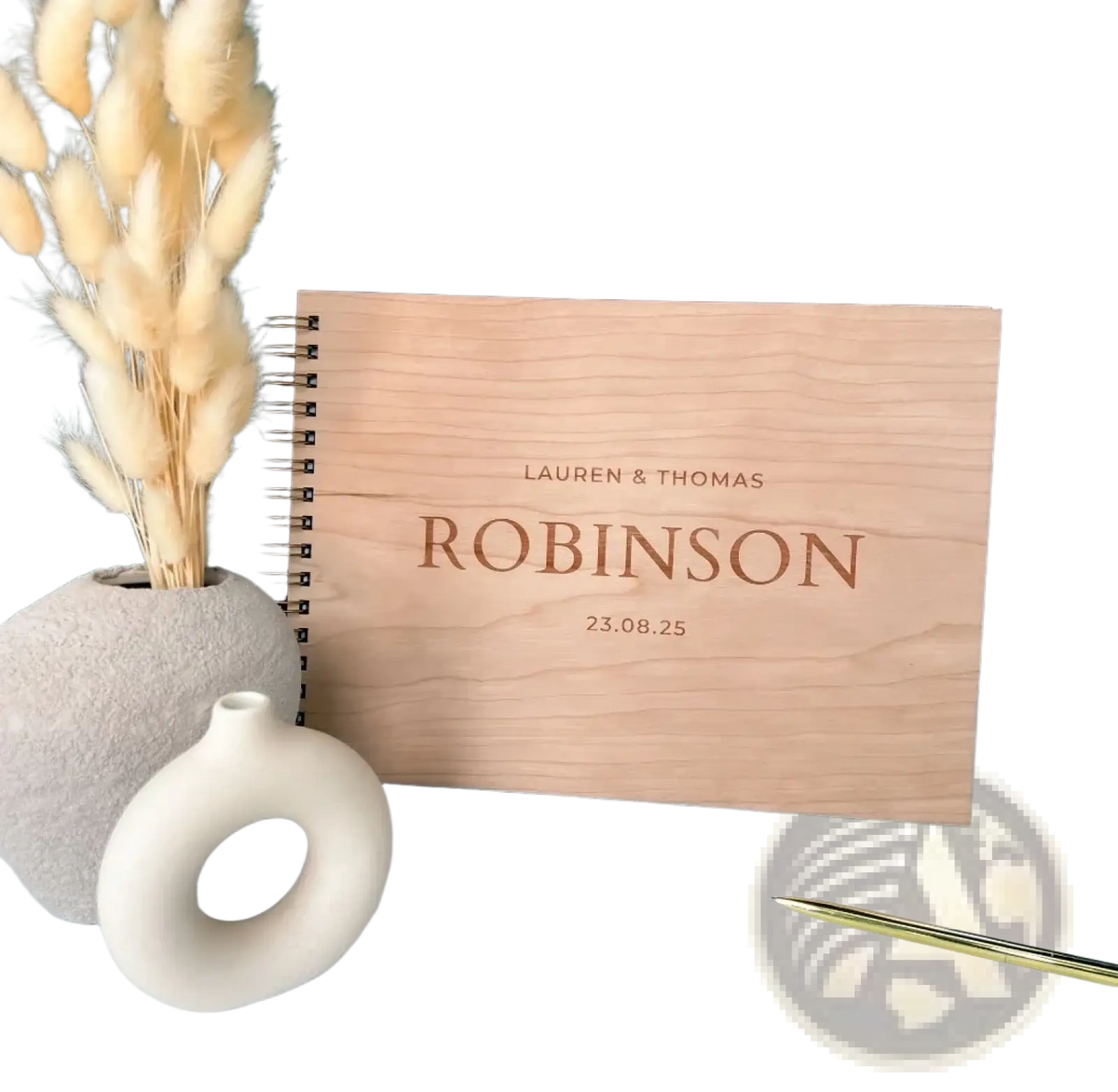 Light-colored wooden wedding guest book album with engraved names and date for personalized wedding keepsake
