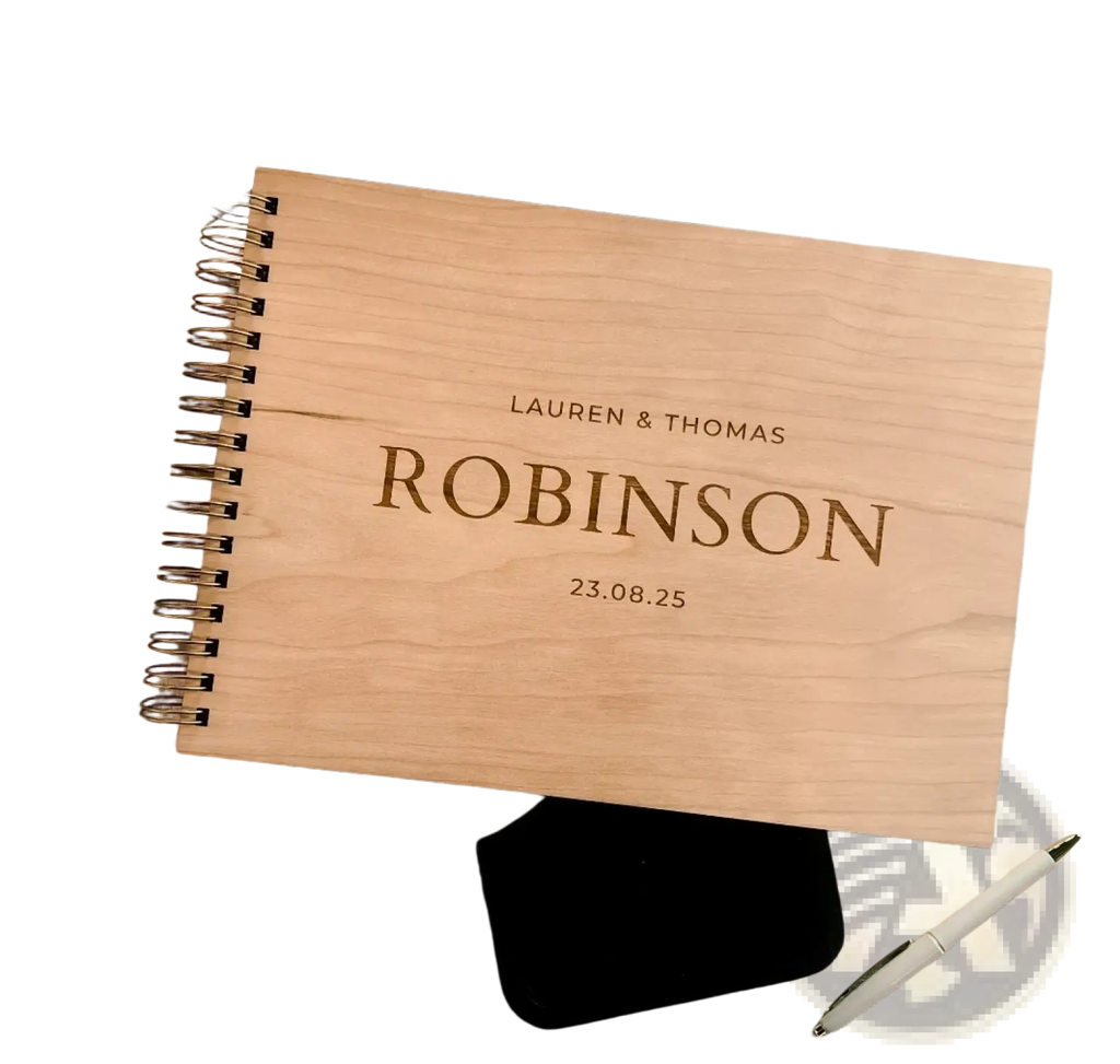 Personalized light-colored wooden spiral-bound wedding guest book album with engraved names and date