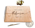 Personalized wooden wedding guest book album in light-colored wood with engraved names and date for wedding use