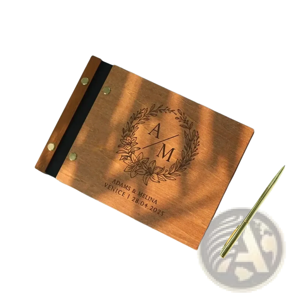 Personalized wooden wedding guest book with laser engraved monogram floral wreath and brass rivets along the spine