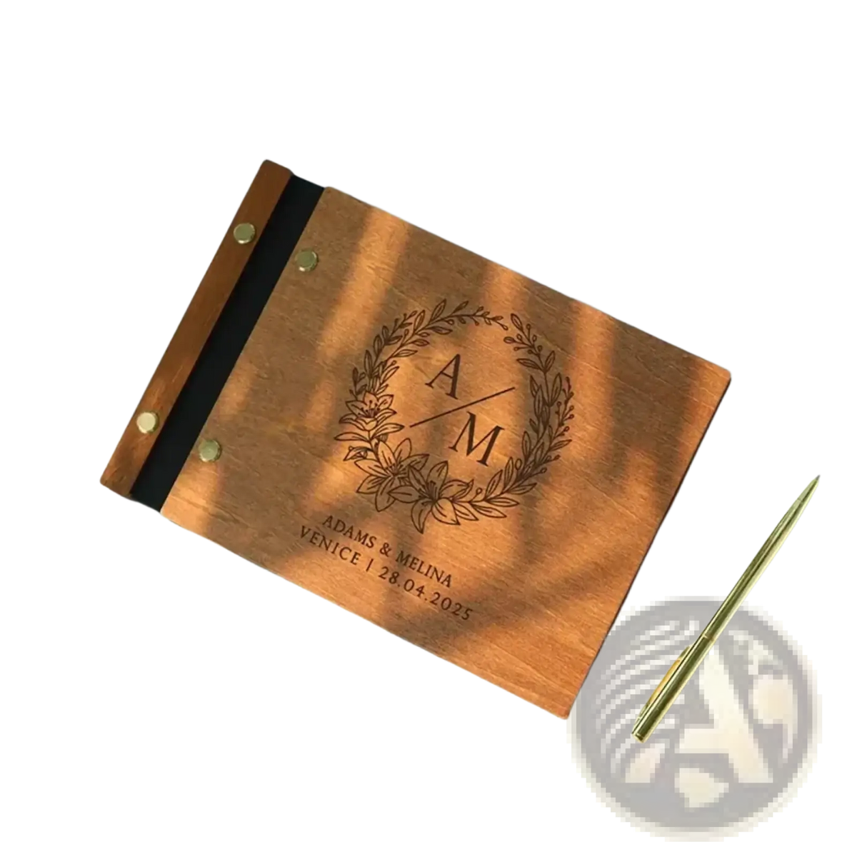 Personalized wooden wedding guest book with laser engraved monogram floral wreath and brass rivets along the spine