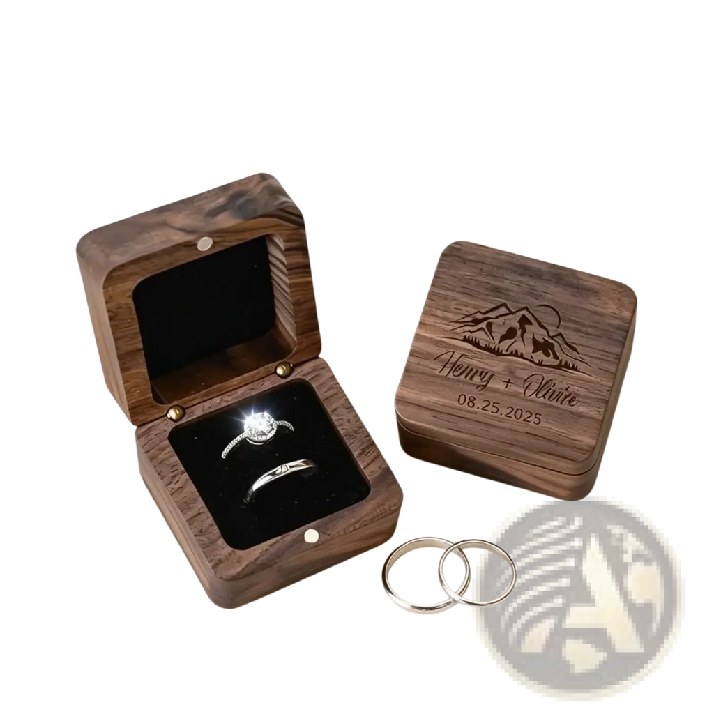 Dark wood engraved personalized wooden wedding ring box with mountain design holding diamond engagement ring and band
