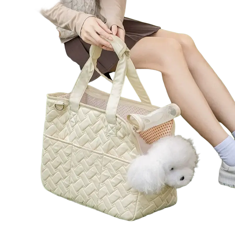 Cream-colored quilted pet bag with breathable mesh sides featuring a small fluffy white dog peeking out