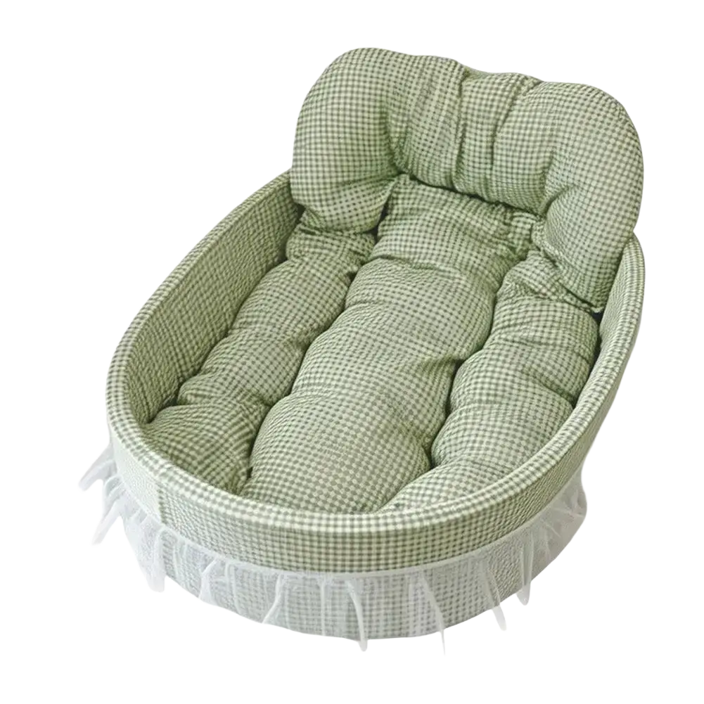 Cozy oval fabric pet bed with soft green and white gingham lining and tufted cushioning for small dogs