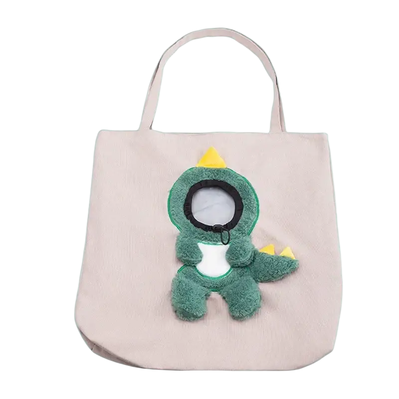 A soft green plush dinosaur with yellow spikes on a beige canvas carrier bag designed for small dog cat use