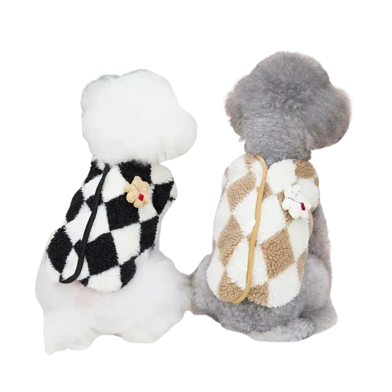 Two fluffy dogs wearing cozy fleece puppy jumpsuit plaid coats in black and white and beige pet clothing designs