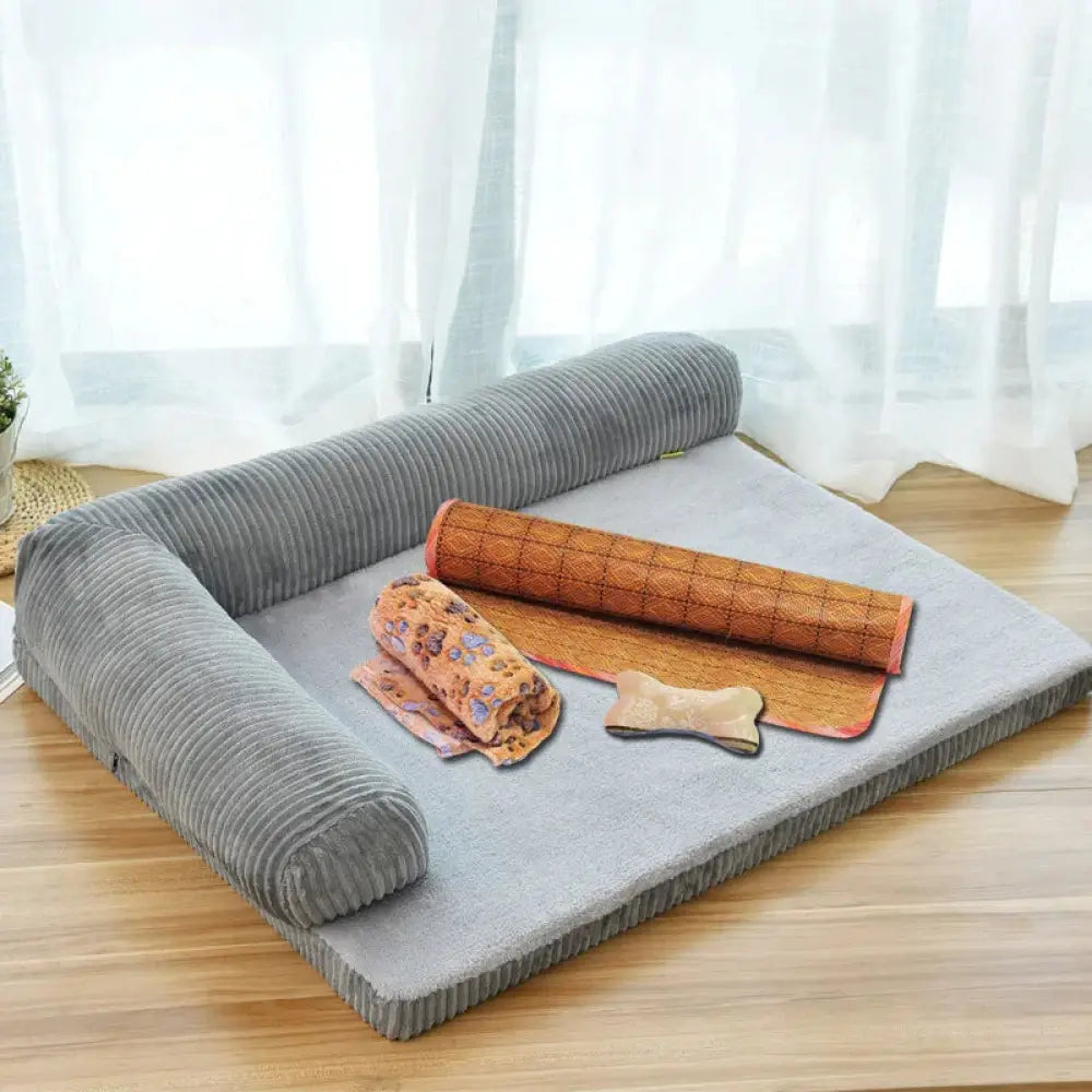 Premium gray corduroy plush orthopedic pet bed with rolled-up bamboo mat and floral towel on top for comfort