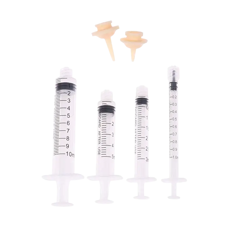 Set of four clear plastic pet feeding syringes with black markings 3ml 5ml 10ml and beige silicone tips