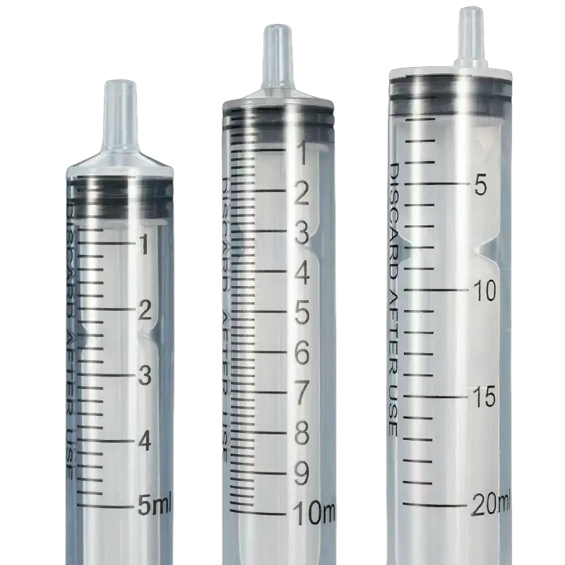 Three transparent plastic pet feeding syringes with black markings and metallic caps labeled discard after use 5 pack