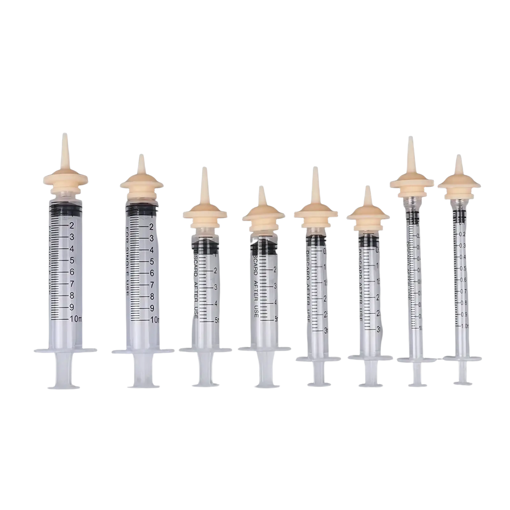 Clear plastic pet oral syringe feeding set with beige caps black measurement markings and silicone nipples