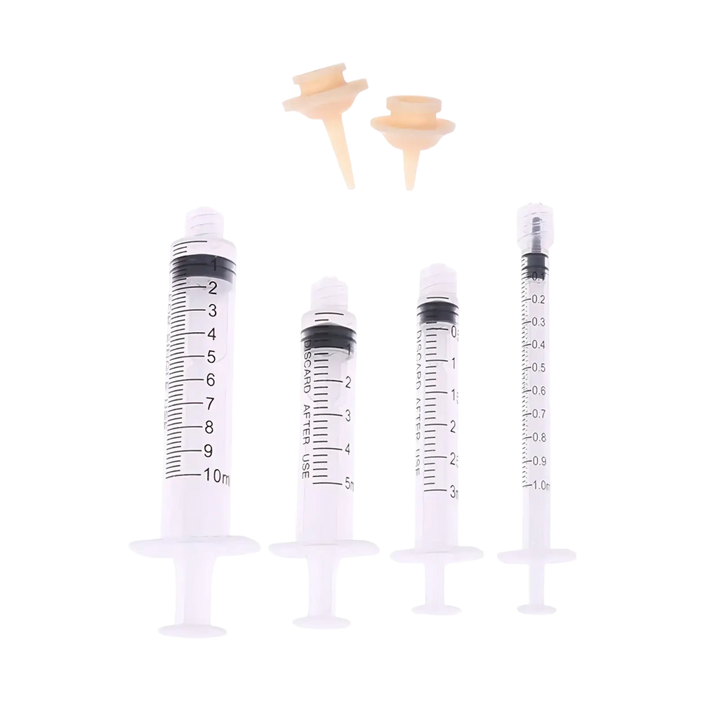 Set of four clear plastic pet oral syringes with black markings and two beige silicone feeding nipples