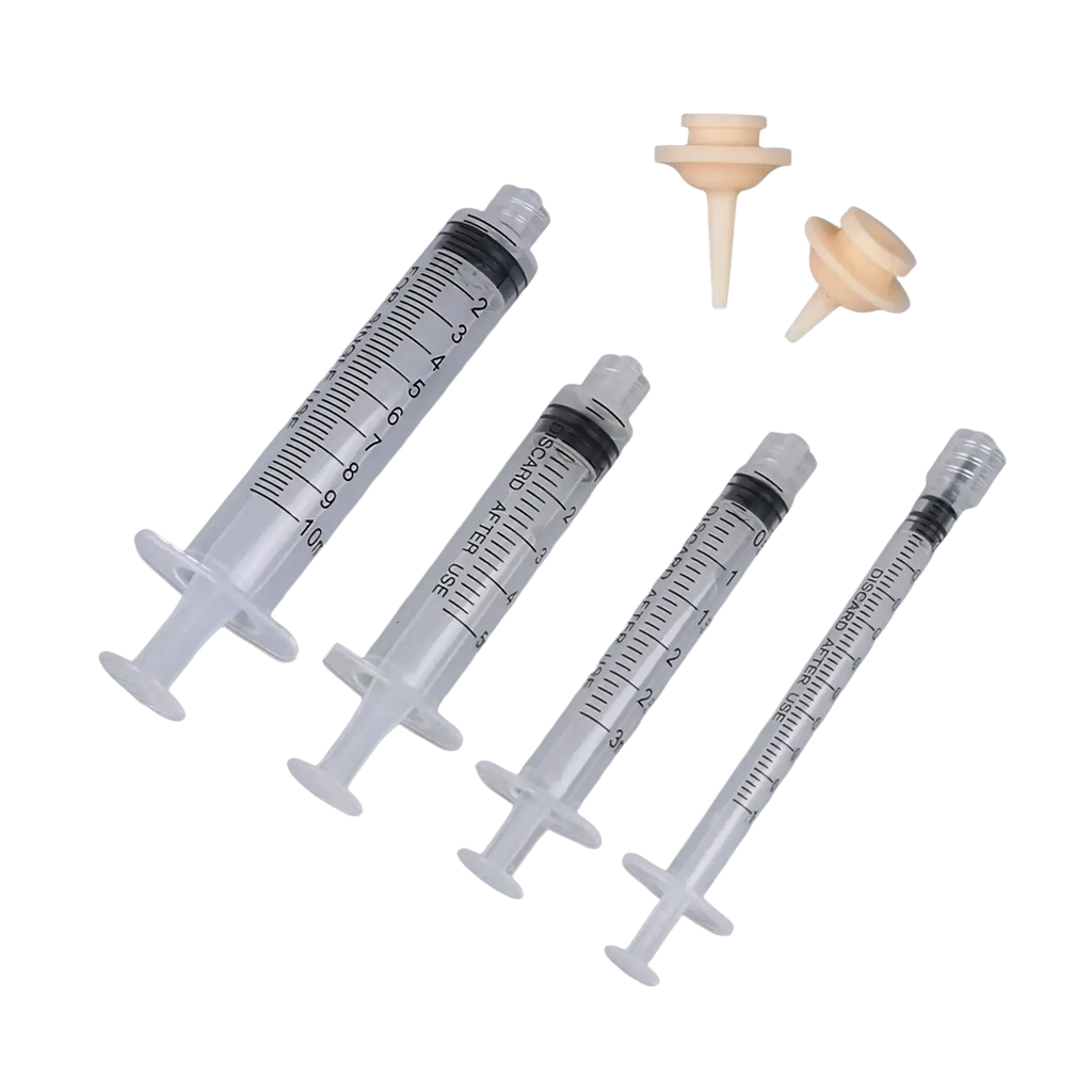 Set of four clear plastic pet oral syringes with black rubber plungers and two beige silicone feeding nipples