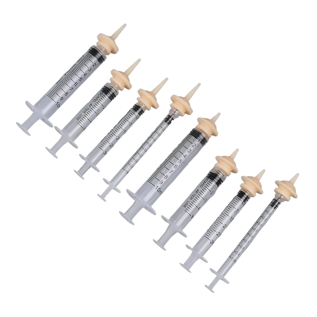 Set of six clear plastic pet oral syringes with beige caps and black measurement markings for feeding use