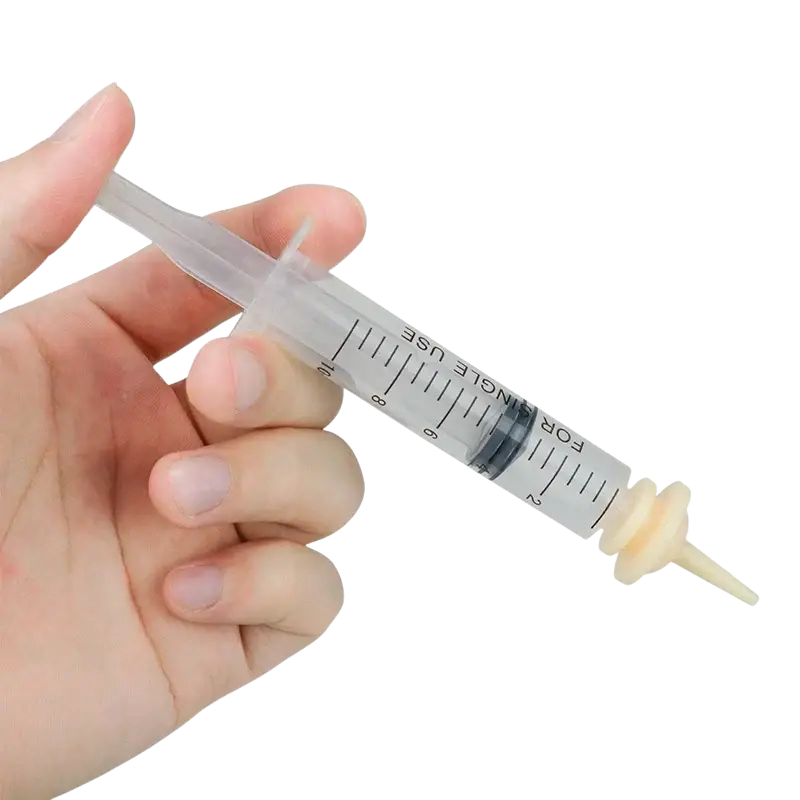Clear plastic pet oral syringe with beige silicone nipple feeder and black measurement markings for precise feeding