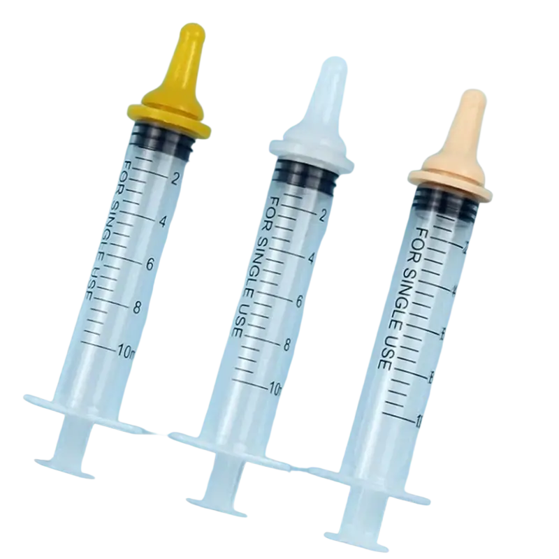 Three transparent plastic pet oral syringes with silicone nipple feeders and yellow, white, beige caps for feeding
