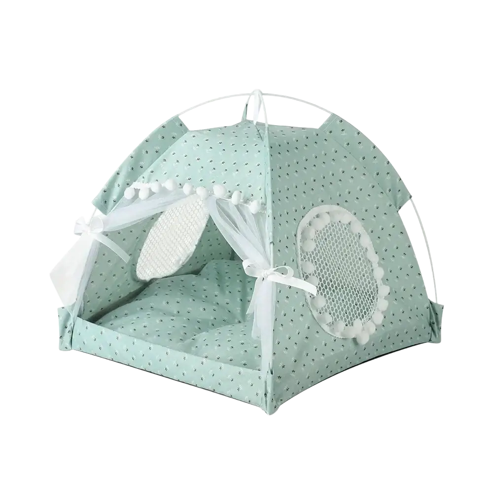 Mint green pet tent with delicate polka dot pattern, white mesh windows with pom-poms, and sheer curtains tied with bows
