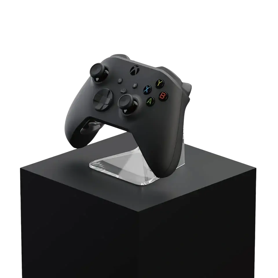 Black Xbox Series X controller with colorful buttons and textured grip placed on phantom stand controller holder rack